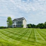 Large freshly mowed lawn with professional crosshatch mowing pattern